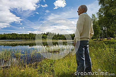 Retired senior by a lakeside Stock Photo