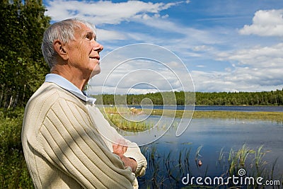 Retired senior by a lakeside Stock Photo