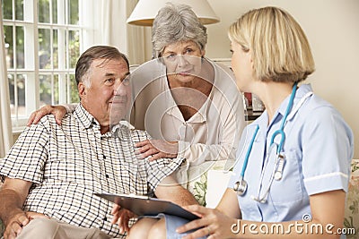 Retired Senior Man Having Health Check With Nurse At Home Stock Photo