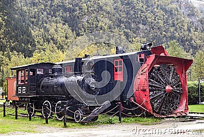 Old locomotive and snow plow in Skagway, Alaska. Editorial Stock Photo