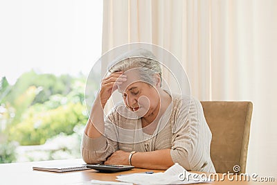 Retired woman calculating her domestic bills Stock Photo