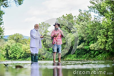 For retirement brings repose. granddad and drandson fishing. Idea attracting money. Fishermen. hobby and recreation Stock Photo