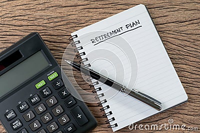 Retirement plan concept, calculator with empty notepad with pen and handwriting headline as Retirement Plan on wood table, plan of Stock Photo