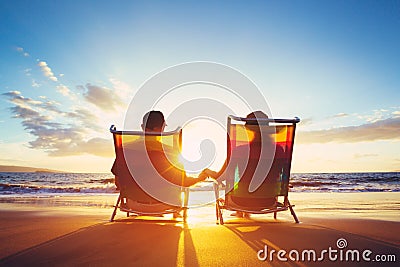 Retirement Vacation Concept, Mature Coupe Watching the Sunset Stock Photo