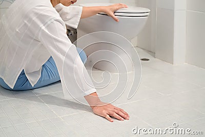 Retirement woman fell down in a restroom Stock Photo