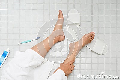 Retirement woman fell down in a restroom Stock Photo