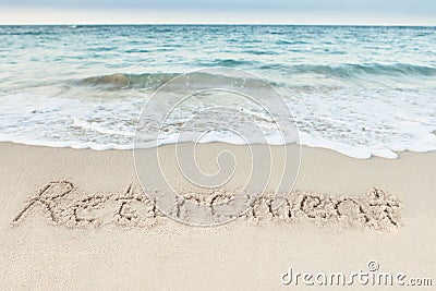 Retirement written on sand by sea Stock Photo