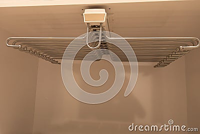 Retractable hanger for trousers and ties inside the wardrobe Stock Photo
