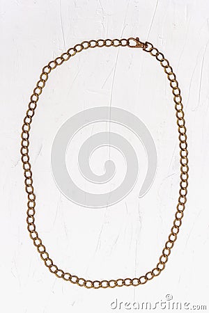 Retro accessory golden belt chain laid out in a rounded frame on a white background Stock Photo