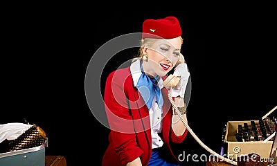 Retro Airline Stewardess Preparing for Work and Talking on the T Stock Photo
