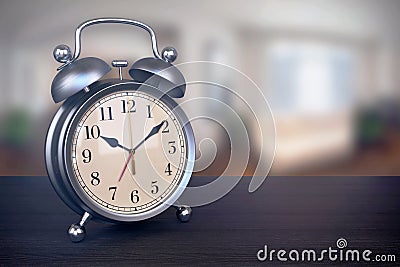 Retro alarm clock on bedside table in bedroom Stock Photo