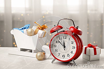 Retro alarm clock, gifts and festive decor on table Stock Photo