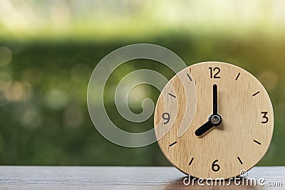 Retro alarm clock on wooden table Stock Photo