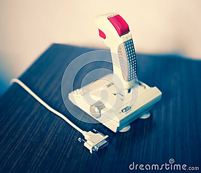 Retro arcade joystick with red button and interface bokeh background Stock Photo