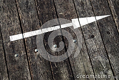 White arrow on a wooden Stock Photo