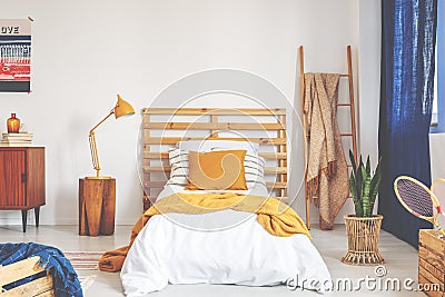 Retro bedroom interior designed for kid, real photo with copy space on the empty white wall Stock Photo