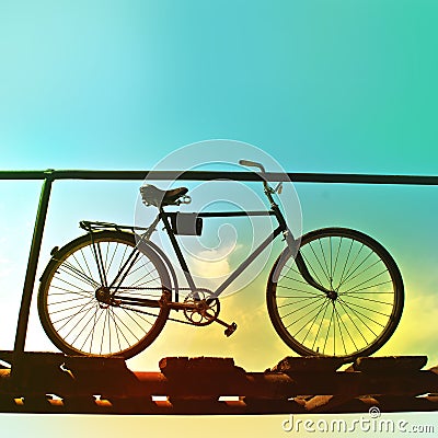 Retro bike on an old wooden bridge. Stock Photo