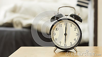 Retro black alarm clock show 6 o'clock in the morning Stock Photo