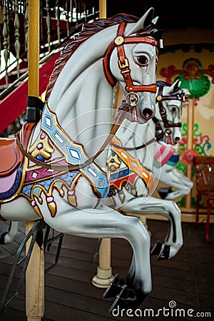 Retro carousel white, black horse. Old wooden horse carousel. Editorial Stock Photo