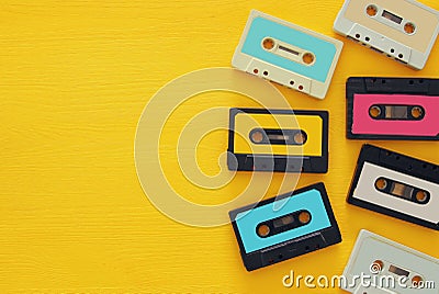 Retro cassette tape collection over yellow wooden table. top view. copy space Stock Photo