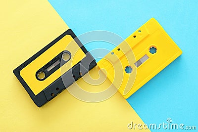 Retro cassette tape over yellow and blue double colorful background. top view. copy space. Stock Photo