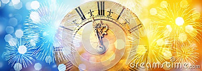 Retro clock close to midnight, fireworks and lights. New Year`s and Christmas background Stock Photo