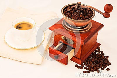 Retro coffee mill and cup of coffee on white background Stock Photo