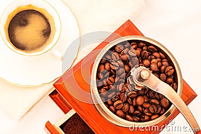 Retro coffee mill and cup of coffee on white background Stock Photo