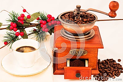 Retro coffee mill and cup of coffee on white background Stock Photo