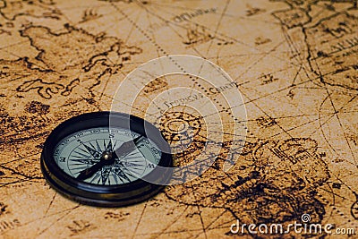 Retro compass on antique world map Stock Photo