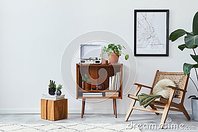 Retro composition of living room interior with mock up poster map, wooden shelf, book, armchair, plant, cacti, vinyl recorder. Stock Photo