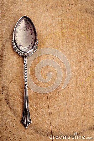 Retro dessert spoon on old wooden table Stock Photo