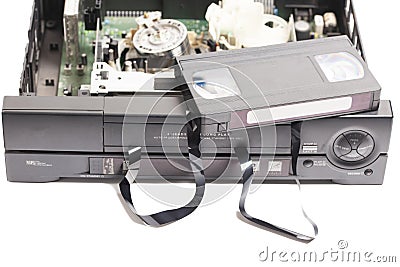 Retro disassembled video cassette recorder with broken VHS cassette with unwound tape isolated on white background. Stock Photo