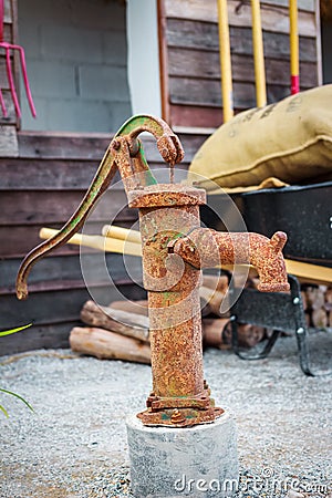 Retro drinking water fountain with hand pump . Stock Photo