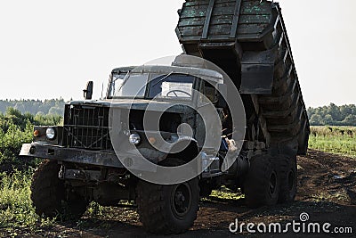 Retro dump truck on a quarry with a raised body Stock Photo