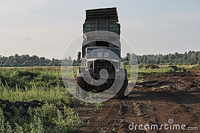 Retro dump truck on a quarry with a raised body Stock Photo