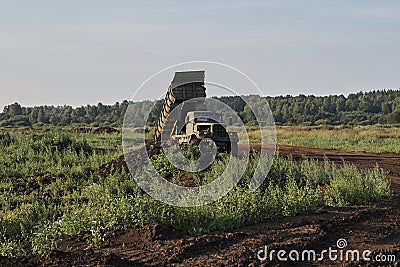 Retro dump truck on a quarry with a raised body Stock Photo