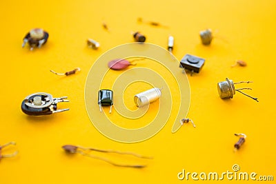 Retro electronic components in yellow background, concept Stock Photo