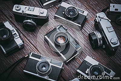 Retro film cameras on wooden background. Editorial Stock Photo