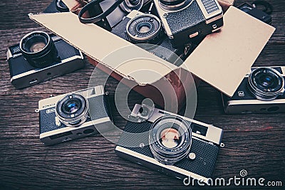 Retro film cameras on wooden background Editorial Stock Photo