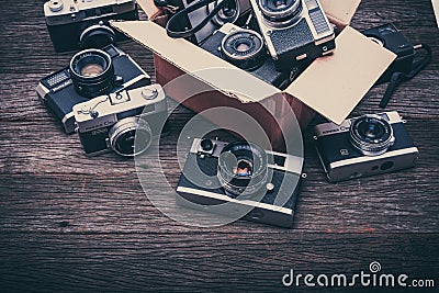 Retro film cameras on wooden background Editorial Stock Photo