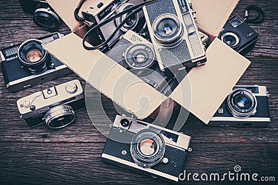 Retro film cameras on wooden background Editorial Stock Photo