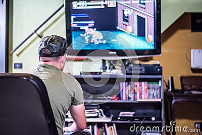 Retro gamer in front of the TV Stock Photo