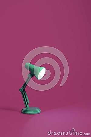 Retro green desk lamp on pink Stock Photo