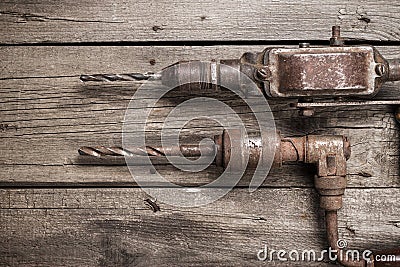 Retro hand drills on wooden table Stock Photo