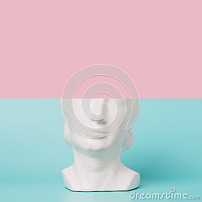 Retro head sculpture against the two tone pastel background. Stock Photo