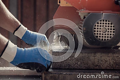 Retro image of workman using an angle grinder or circular saw to Stock Photo