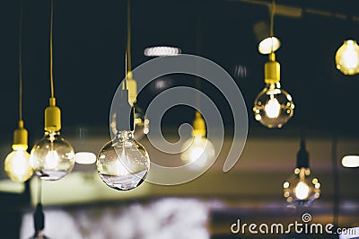 Retro light bulbs hanging in department store, with decorate interior luxury, fixtures combine beautiful modernity Designer, lamps Stock Photo