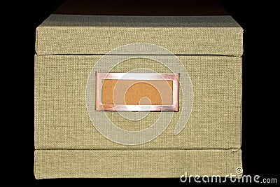 Retro Light khaki file-storage box covered with tweed fabric with blank label in copper frame Stock Photo