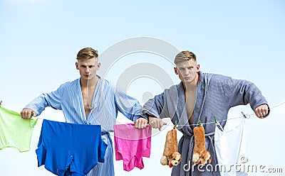 Retro male housewife. twins men. Maid cares about house. Vintage housekeeper men. Multitasking twins. Performing Stock Photo